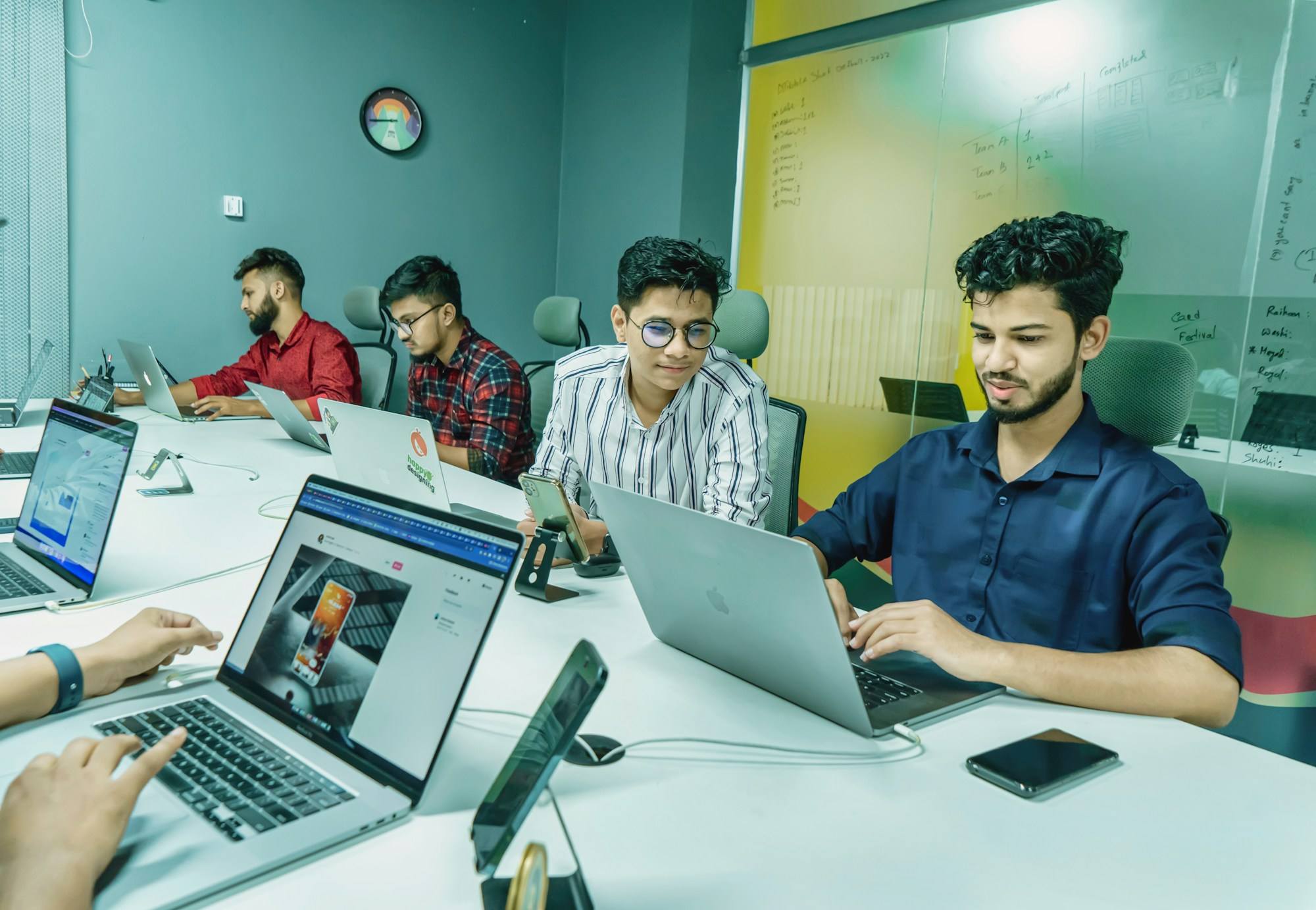 An Indian start-up team working on laptops