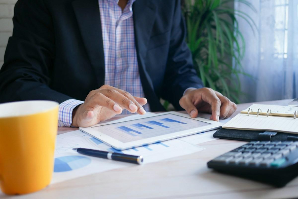 Executive reviewing financial reports on a tablet